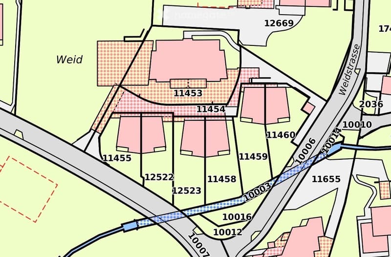 Floor plan showing multiple buildings and plots with numbered sections, surrounded by roads and pathways.