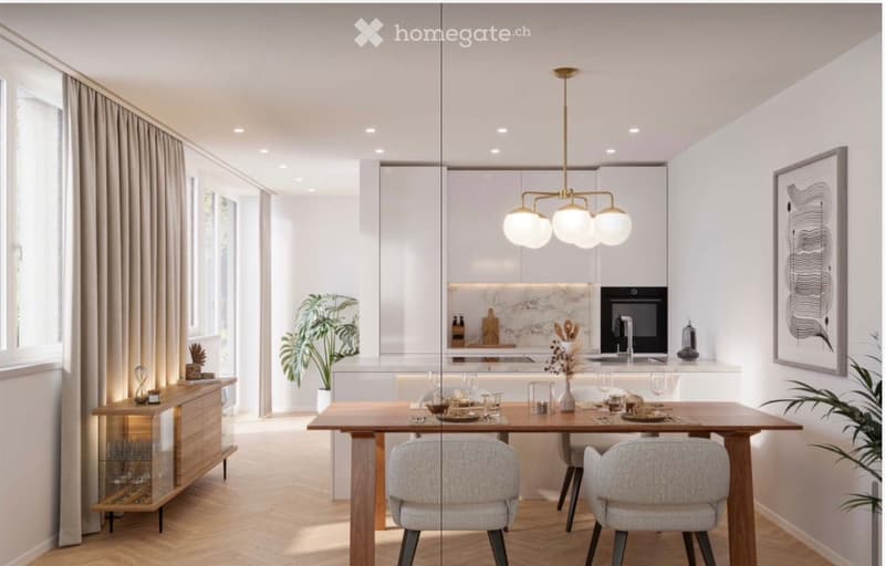 Modern, open-plan dining and kitchen area with a wooden dining table, grey upholstered chairs, a sleek chandelier, and a contemporary kitchen featuring white cabinets, a marble backsplash, and stainless steel appliances.