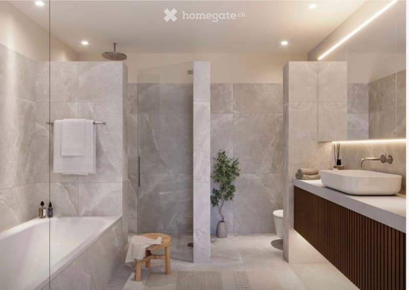 Modern bathroom with marble tiles, a bathtub, a glass-enclosed shower, a sink with a modern faucet, a small wooden stool, and a decorative plant in a pot.