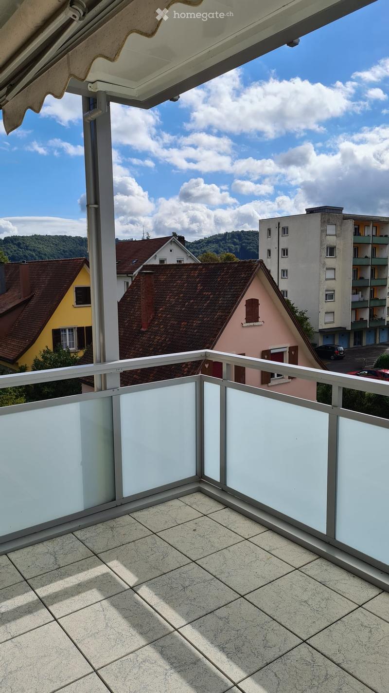 modern balcony with tiled floor and transparent glass balustrade, beautiful view