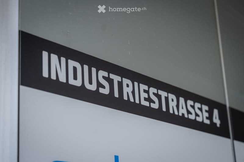 A hallway with a sign reading "INDUSTRIESTRASSE 4" mounted on the wall.