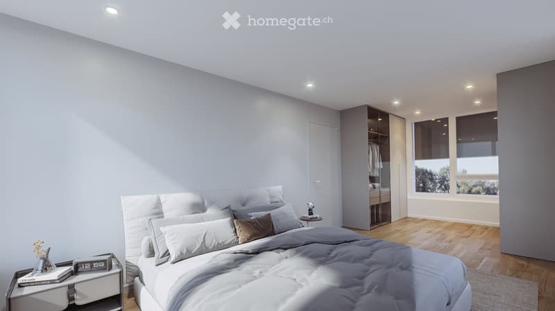 Modern bedroom with a large bed, nightstand, clock, books, vase, and a built-in wardrobe. The room features light grey walls, wooden flooring, and large windows with blinds.
