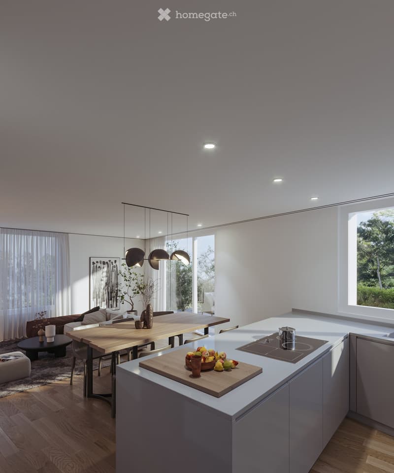 Open-plan living and dining area with a modern kitchen island, wooden dining table, sofa, pendant lighting, and large windows overlooking greenery.