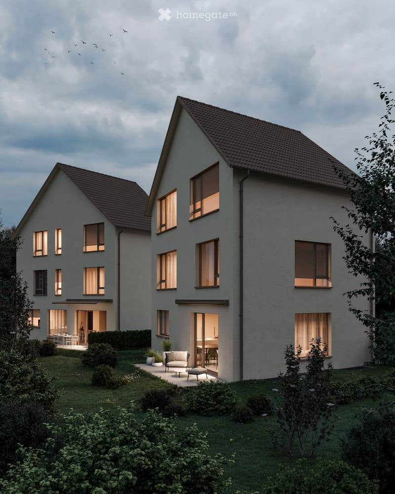Modern two-story house with a sloped roof, large windows, and a well-maintained garden area with seating.