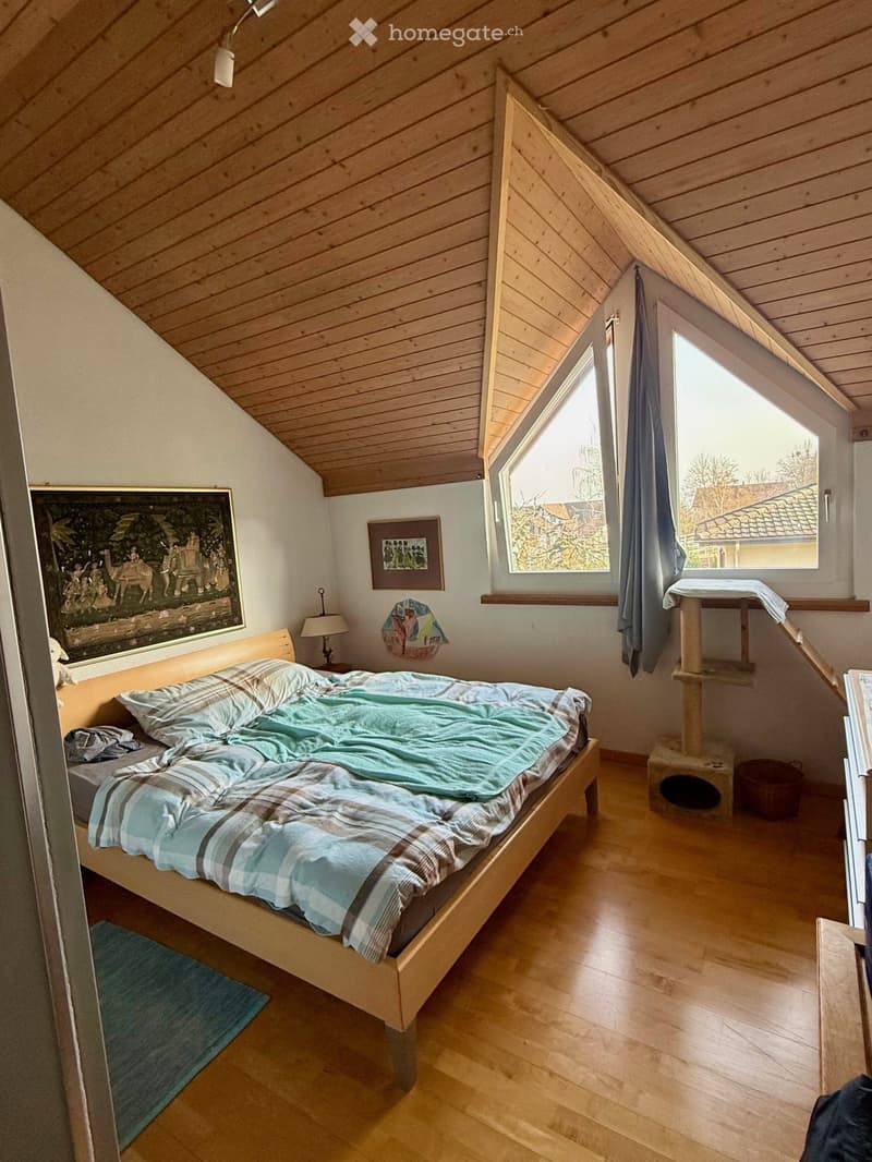 bedroom with wooden floor, bed, lamp, rug, cat tree, painting, window, wooden ceiling