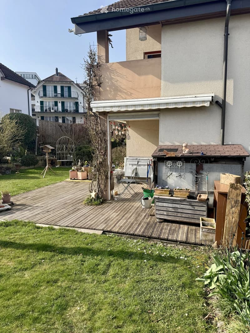 Wooden deck, garden, plants, wooden storage box, awning, garden tools
