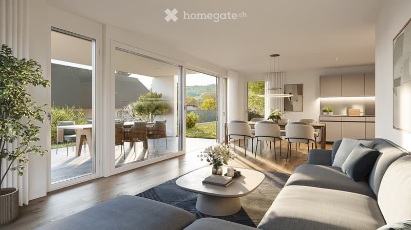 Modern living room with large glass doors leading to a patio, featuring a grey sofa, coffee table, dining area with chairs and table, and a kitchen area with cabinets and a countertop.
