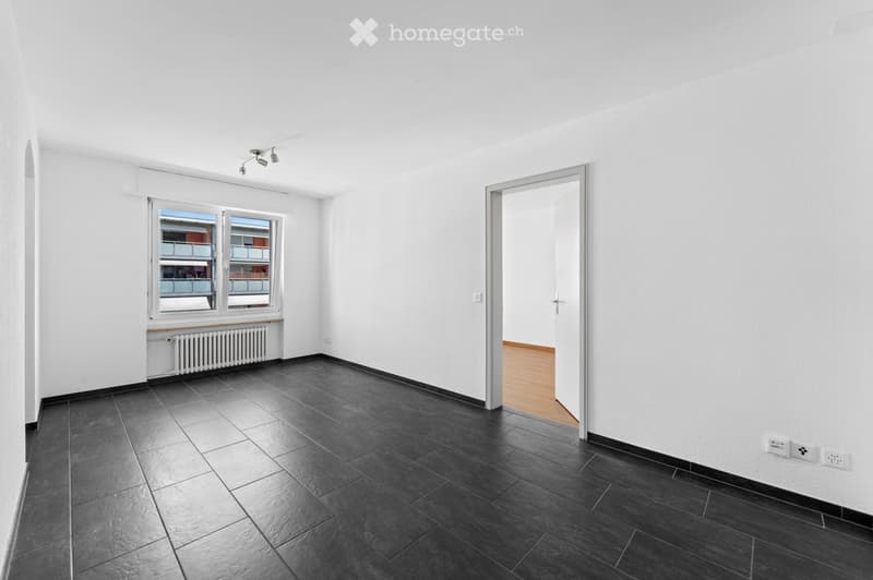 empty room, white walls, black tiled floor, windows, ceiling lights, radiator under window