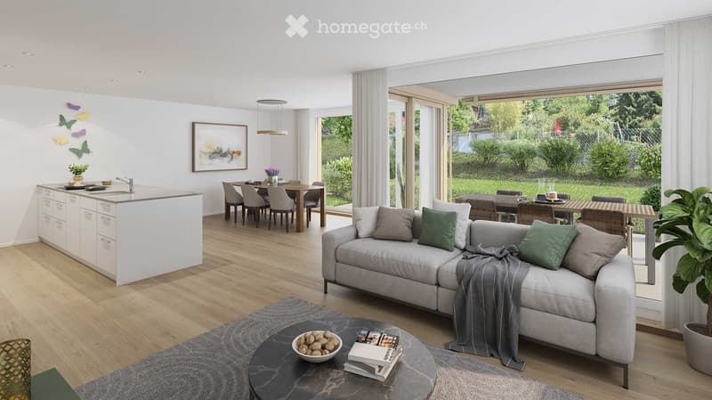 Open-plan living and dining area with a grey sectional sofa, coffee table, dining table with chairs, and a modern kitchen island with a sink and faucet. The space features large windows with sheer curtains, a potted plant, and decorative artwork on the wa