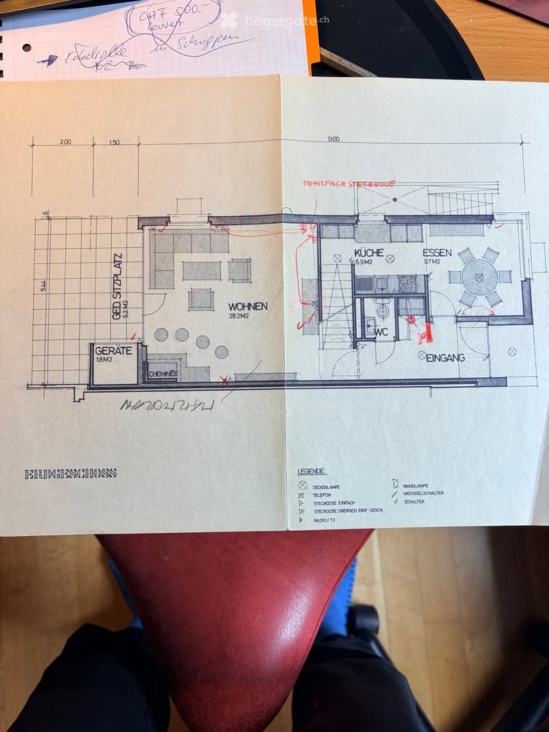 Floor plan of a residential space showing a kitchen, dining area, living room, and utility room with labeled dimensions and symbols for lighting and switches.