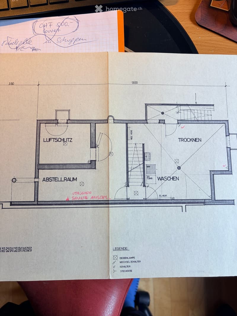 Floor plan showing rooms labeled Luftschutz, Abstellraum, Waschen, Trocken, and Helvert. Includes symbols for ceiling lights, switches, and doors.