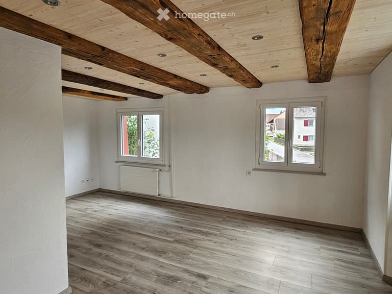empty room, hardwood floors, wooden ceiling beams, white walls, large windows