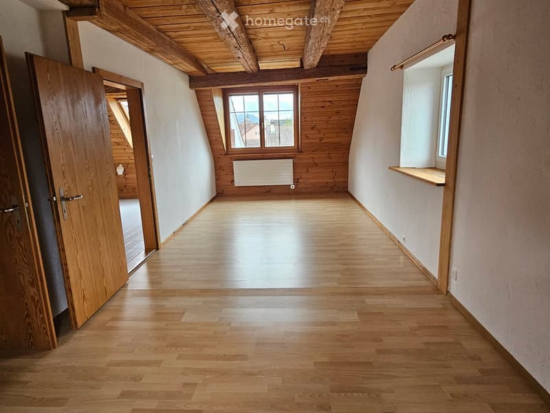 empty room, hardwood floor, wooden beam ceiling, white walls, two windows