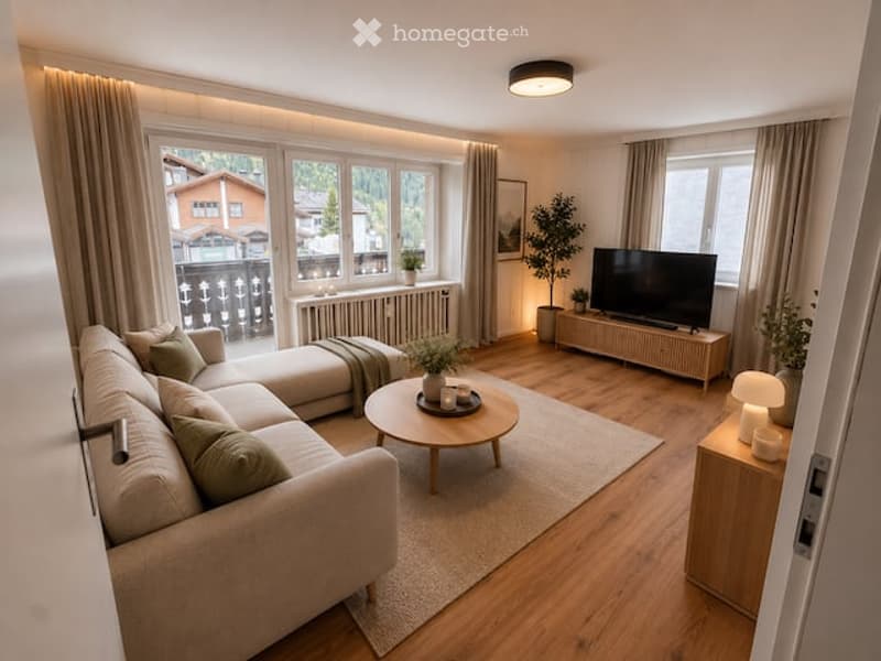 Modern living room with large windows offering a scenic view, featuring a light-colored sectional sofa, a round wooden coffee table, a flat-screen TV on a wooden stand, and several potted plants.