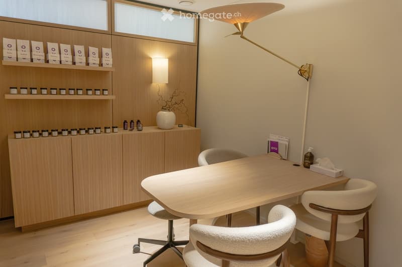wooden desk, 3 chairs, wooden cabinet with shelves, wall lamp, floor lamp, tissue box, bottle, tissue