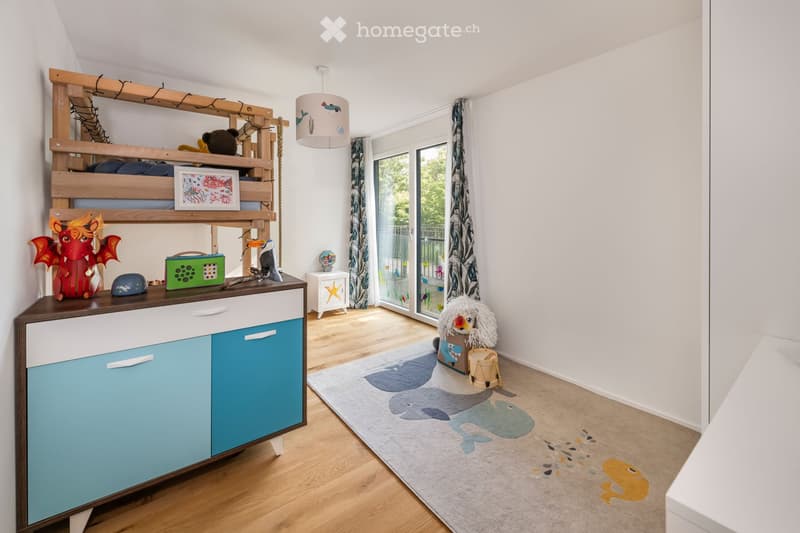 Bright, modern children's bedroom with a bunk bed, colorful cabinet, toys, and a playful rug featuring sea creatures.