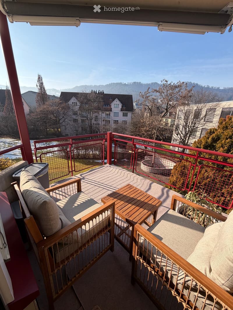 wooden chairs, wooden table, fence, city view