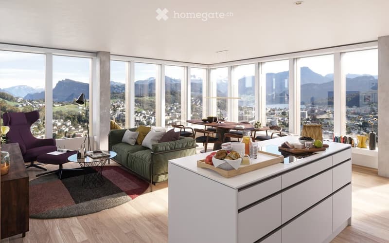Modern open-plan living and dining area with large windows offering a scenic mountain view. Features a green sofa, purple armchair, dining table with chairs, and a kitchen island with food items.