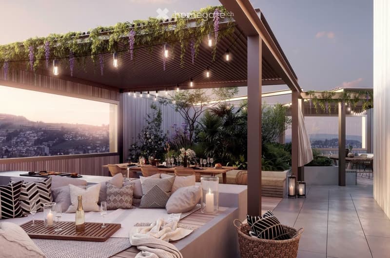 A modern rooftop terrace with a view, featuring a seating area with cushions, a dining table with chairs, and decorative elements like candles and a basket.