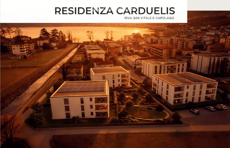Three apartment buildings, solar panels on roofs, greenery, water body, road, cars parked