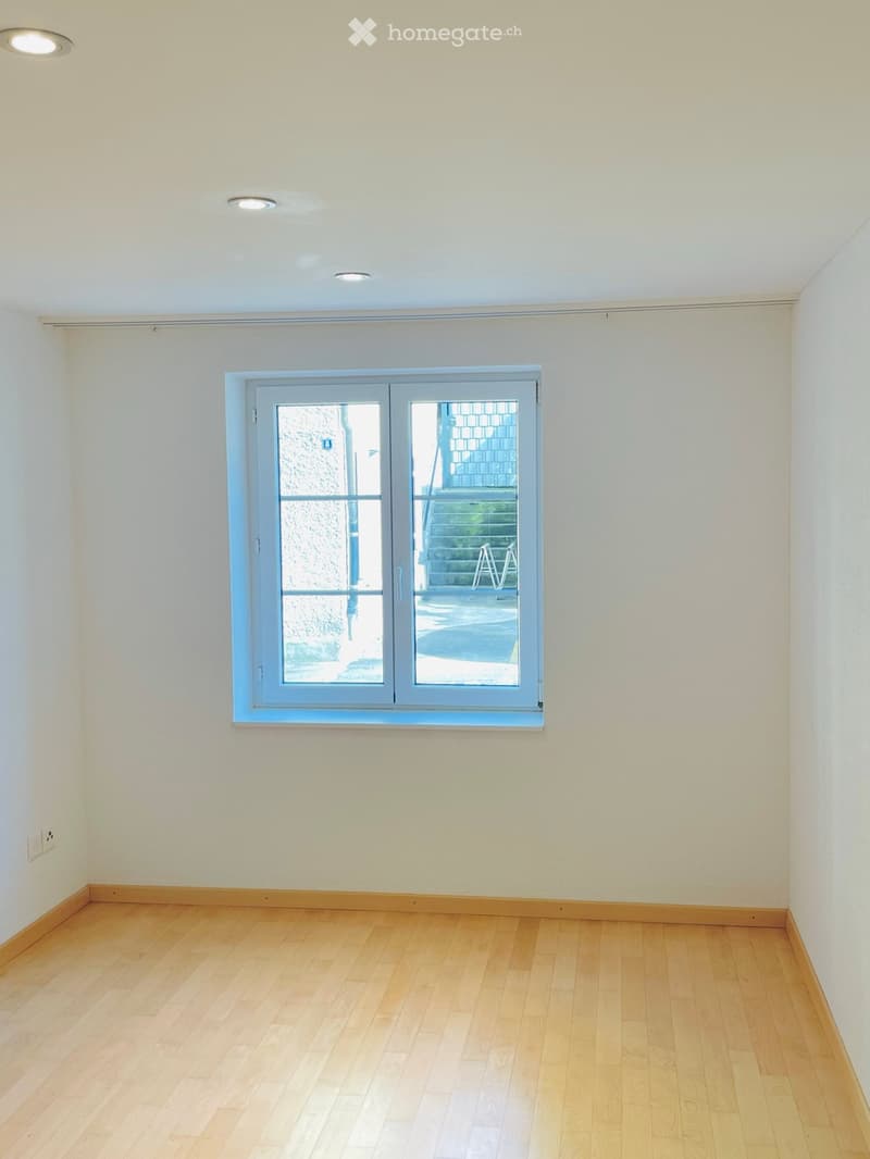 empty room, white walls, wooden floor, white ceiling, window, power outlet