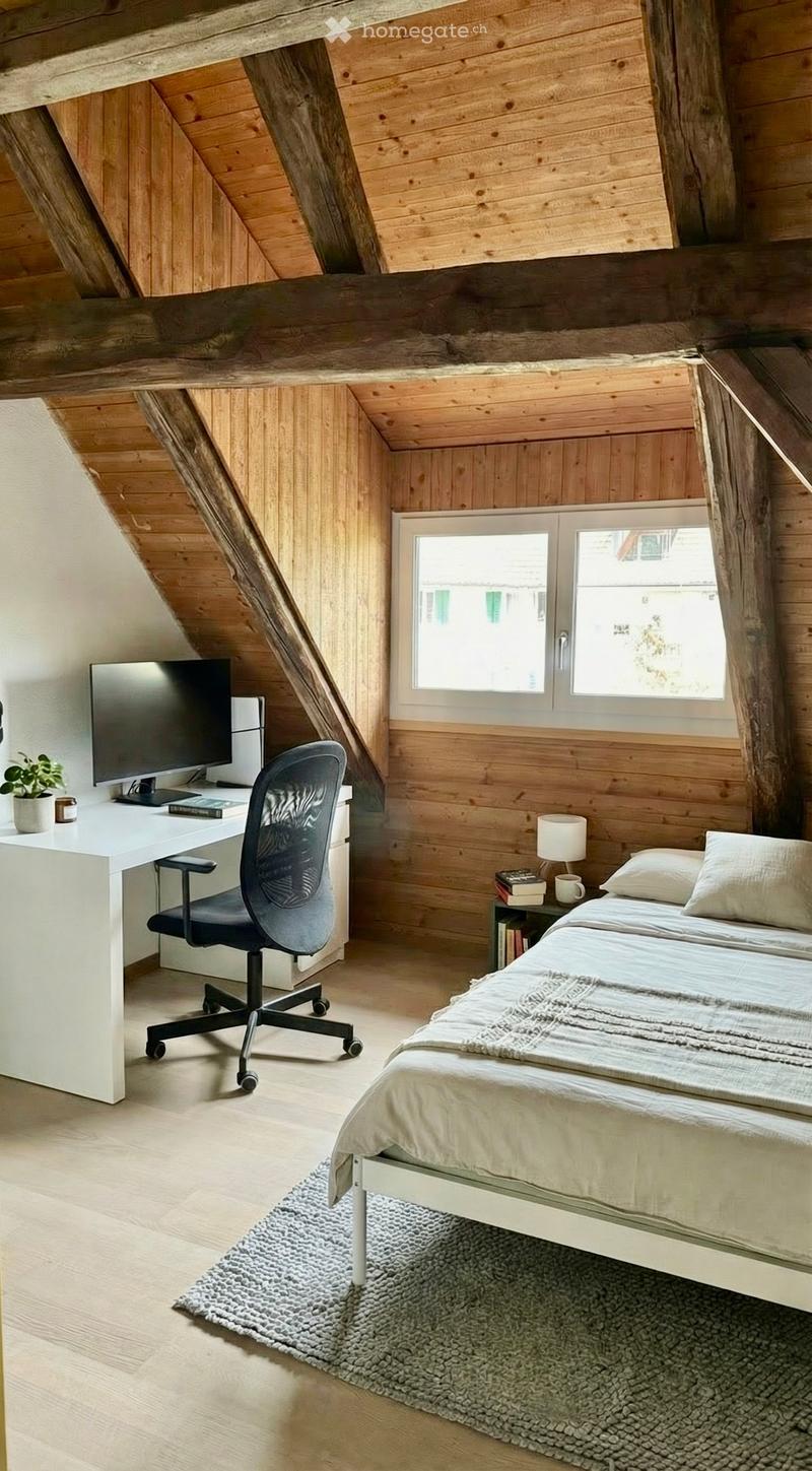 bedroom with wooden walls, desk, chair, bed, rug, lamp, books, plant, window