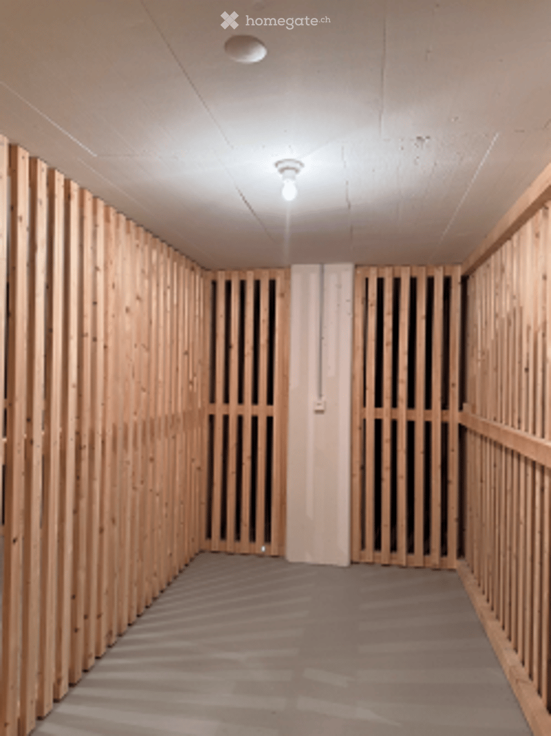 Unfurnished Room. Empty room with wooden panel walls and a grey carpeted floor. No furniture or equipment visible.