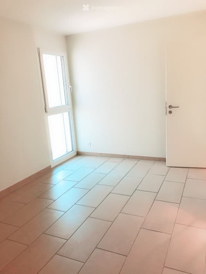 Empty room with a window and a door