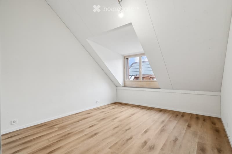 empty room, wooden floor, white walls, window, slanted ceiling