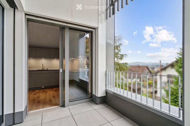 Balcony with glass door leading to kitchen, metal railings, white tiled floor, balcony railing, outdoor area view