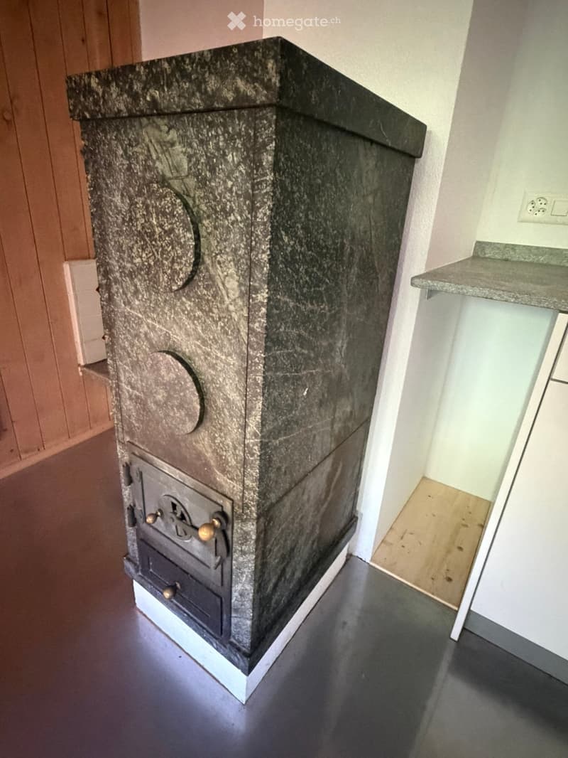 Bathroom with a granite fireplace and a sink visible in the background.