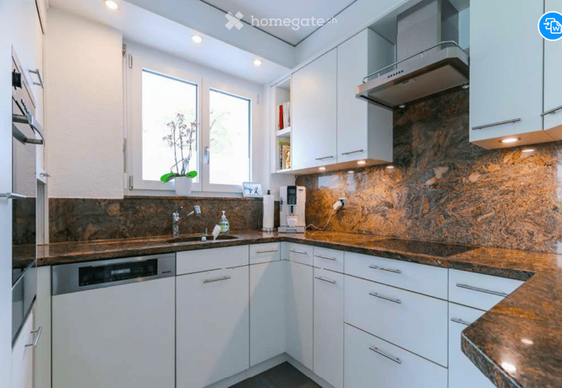 modern kitchen, granite countertops, white cabinets, stainless steel faucet, built-in coffee machine, dishwasher, window with natural light, coffee filter, roll of paper towels, ceramic tile backsplash