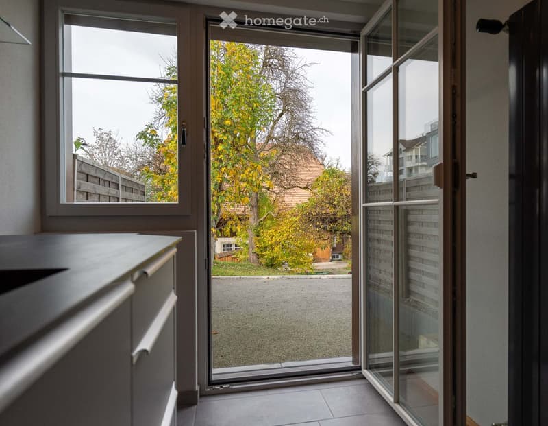 Open sliding door, view of tree and street