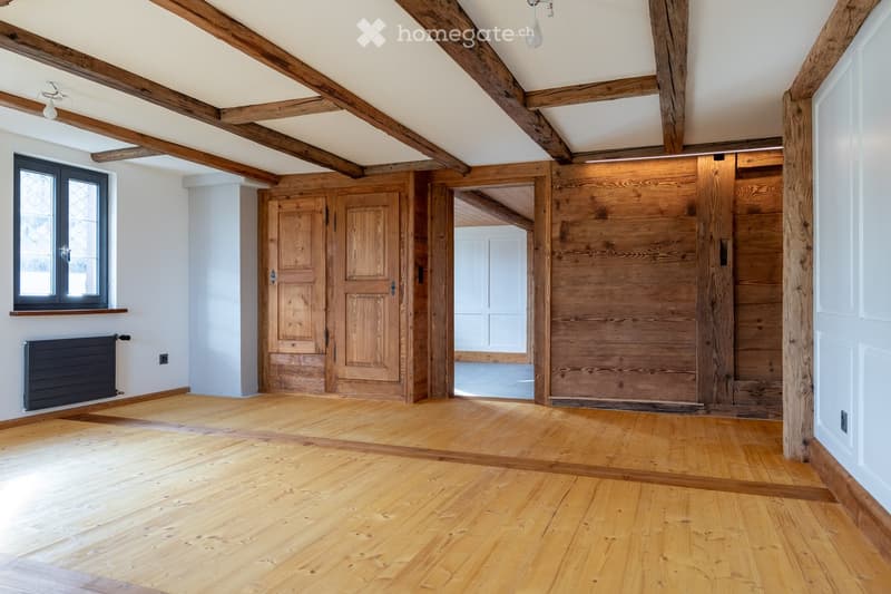 empty room, wooden ceiling beams, wooden doors, window, wooden floor