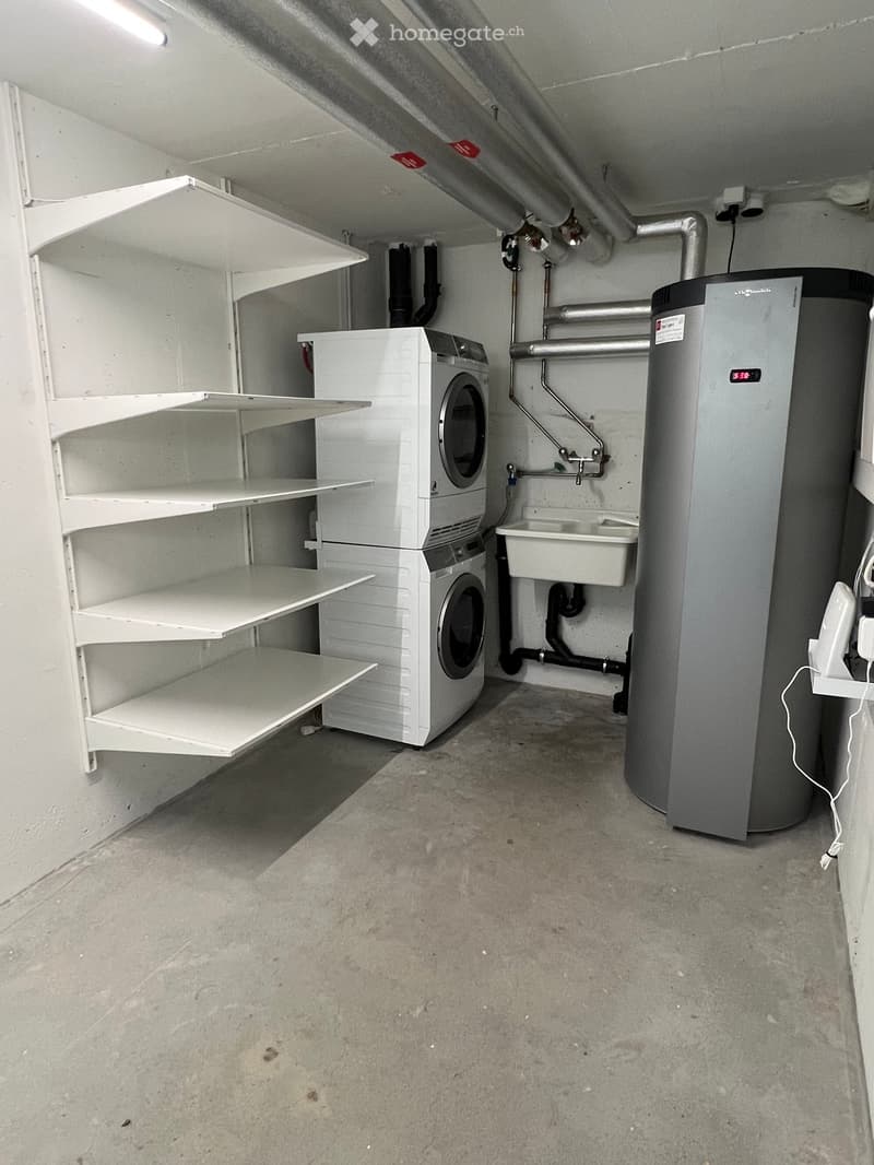 Laundry room with washing machine, dryer, sink, and water heater