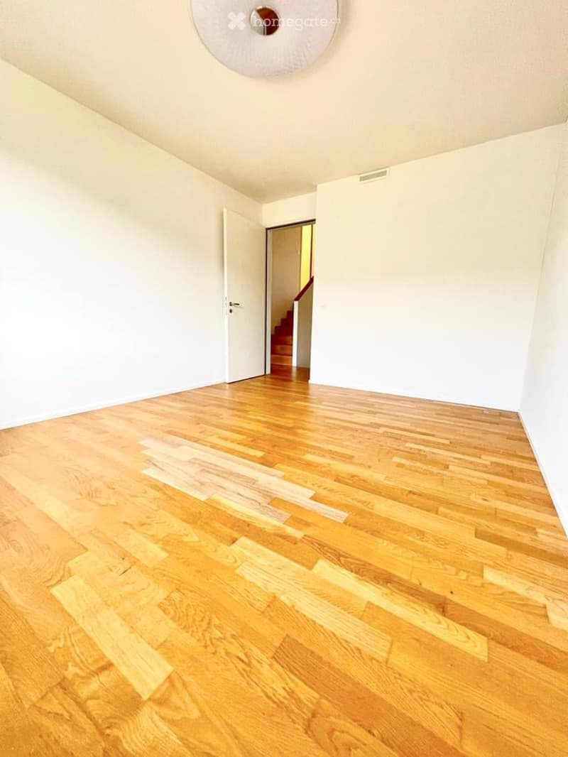 empty room, hardwood floors, white walls, white door, staircase