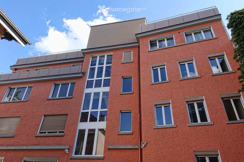 red brick apartment building, many windows, balconies