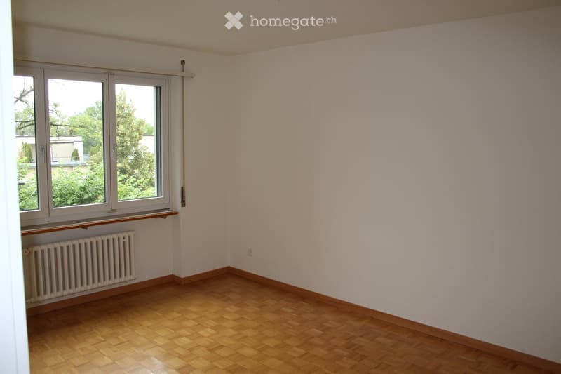empty room, large windows, wooden floor, white walls, radiator