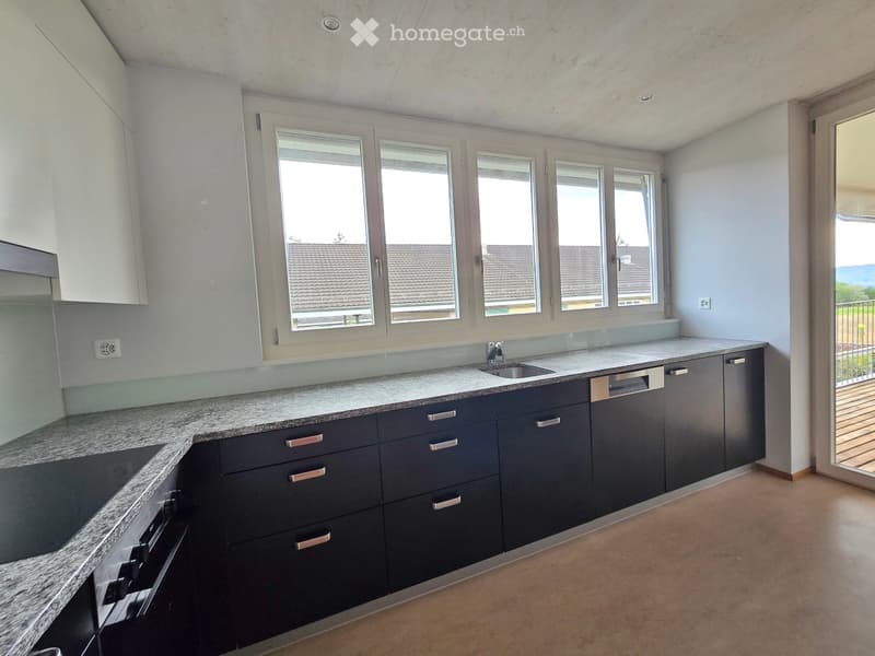 modern kitchen with white cabinets, granite countertops, gas stove, dishwasher, three windows, balcony