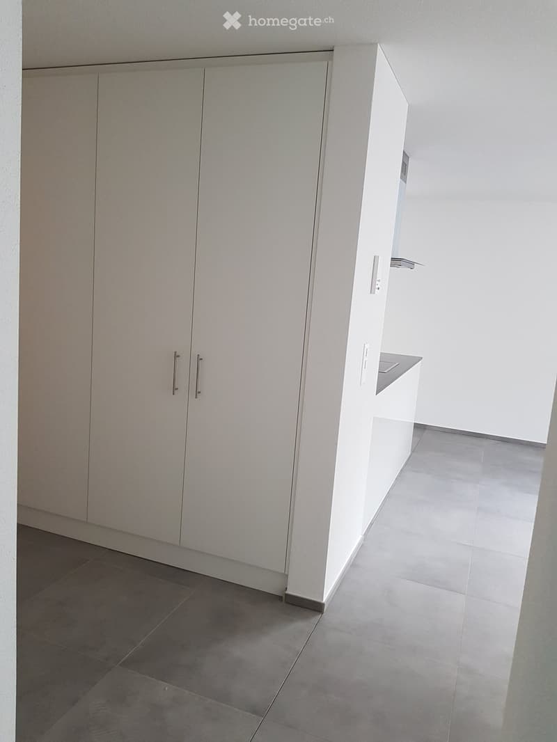 white cabinets, gray tile floor, white walls, empty kitchen area