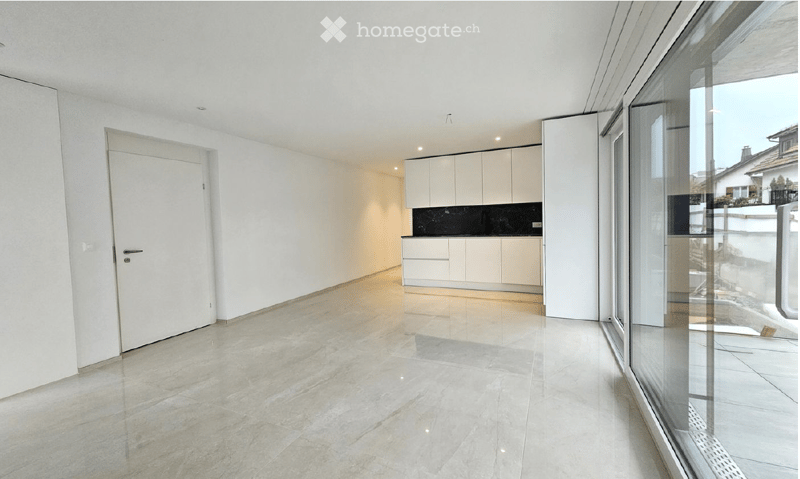 Empty room with white walls, light grey tiled floor, white cabinetry, and large glass window.