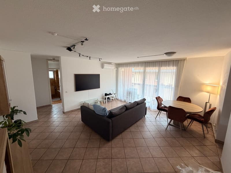 open floor plan, couch, coffee table, dining table, chairs, flat screen tv, window