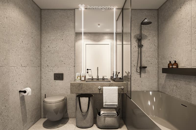 Modern bathroom with a large mirror, sleek sink, bathtub, and showerhead. Features include a toilet, towel, and decorative items on the counter.