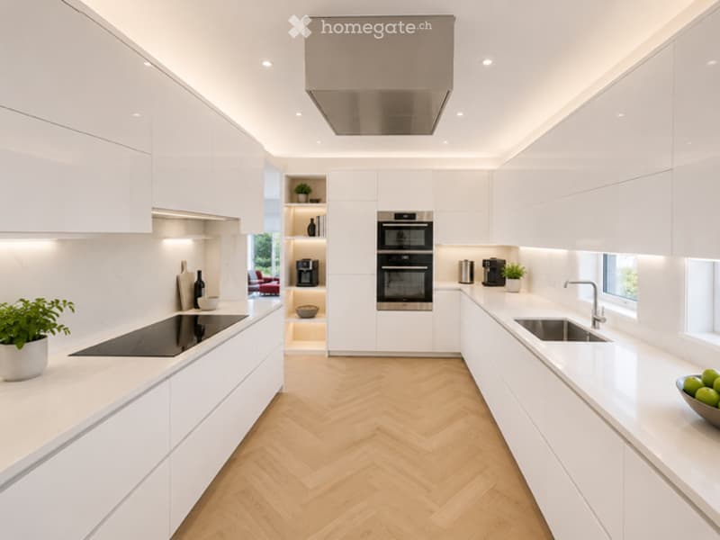 Modern, minimalist kitchen with white cabinetry, herringbone wooden flooring, stainless steel appliances, and sleek countertops.