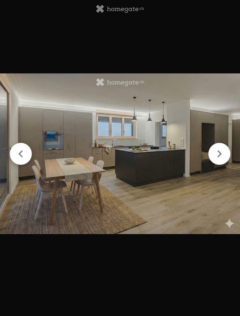 Modern kitchen with a central island, dining table, and chairs, featuring built-in cabinets and appliances.