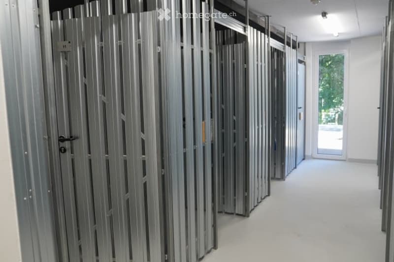 Empty room with exposed metal framing and a large glass door leading to an outdoor area.