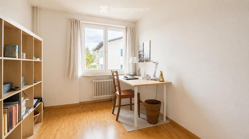 A well-lit study or home office with a wooden desk, chair, bookshelf, and a window view of a residential area.