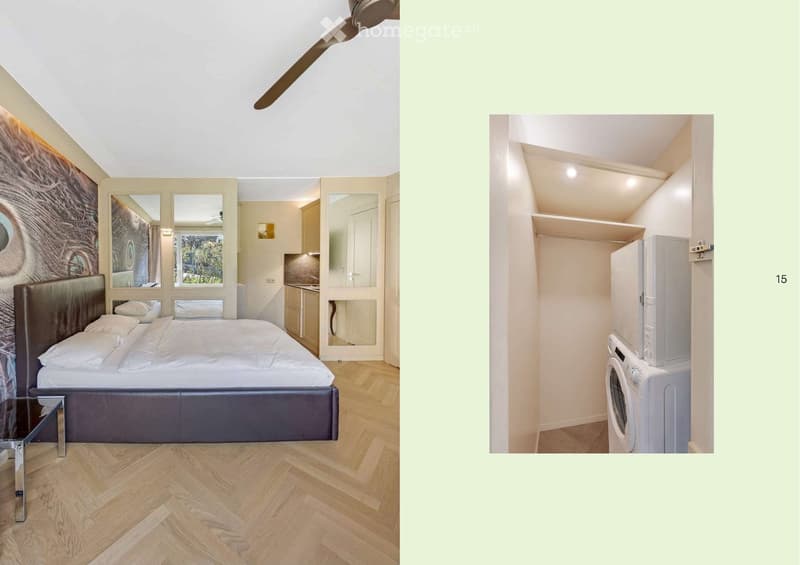The image shows a furnished room with a bed, nightstand, and a separate area with a refrigerator and washing machine. The room features wooden flooring and large windows with a view of greenery.
