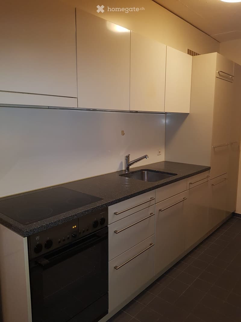 Modern kitchen with white cabinets, stainless steel appliances, granite countertop, and built-in oven and stove.
