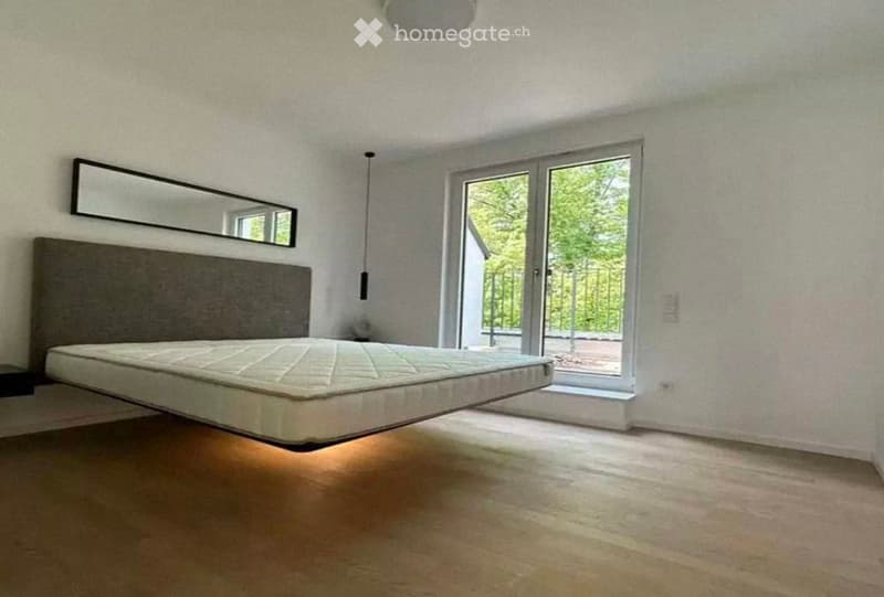 Modern bedroom with a floating bed, large mirror, and sliding glass door leading to a balcony.